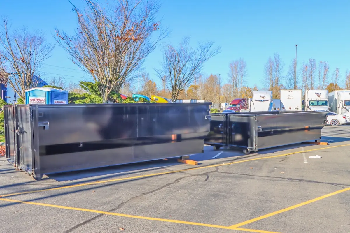 Professional dumpster rental service with roll-off container on residential driveway in Sun Village